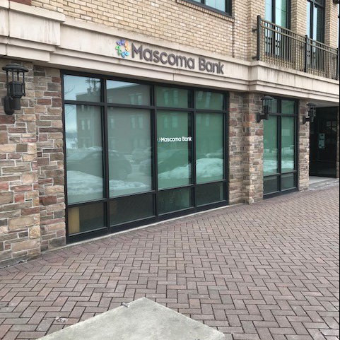 Brick building with glass windows and a Mascoma Bank logo above