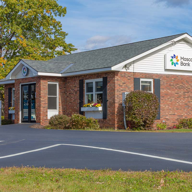 Lancaster branch building. Red brick building with window high shrubbery and window planters landscaping