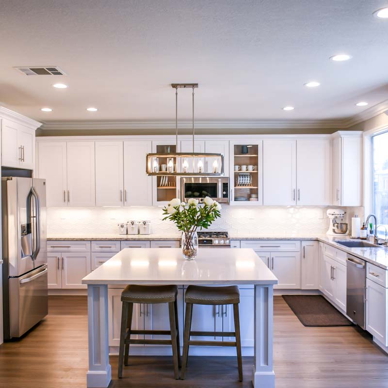 Interior shot of newly renovated kitchen with marble counters and stainless steel appliances